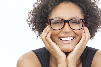 woman smiling with hands on her cheeks