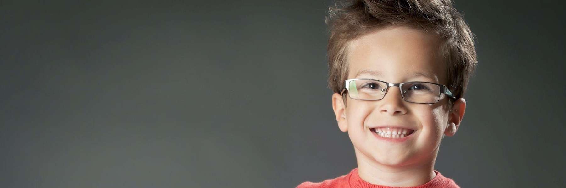 Young boy smiling brightly after a comfortable dental extraction in Topeka.