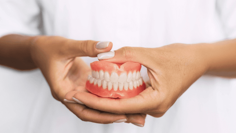 full dentures in the hand