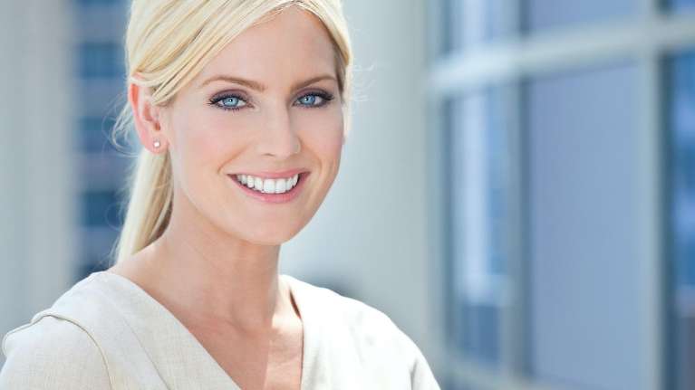 woman with blue eyes and blonde hair smiling