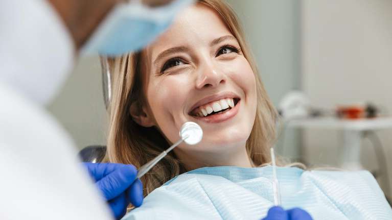 woman sitting in a dental chair | Dentist Topeka, KS