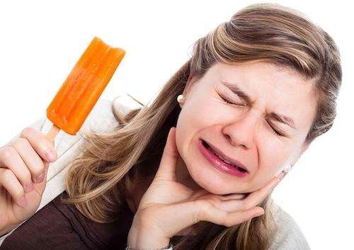 Woman with toothache, reflecting what patients in Topeka can expect before a root canal treatment.