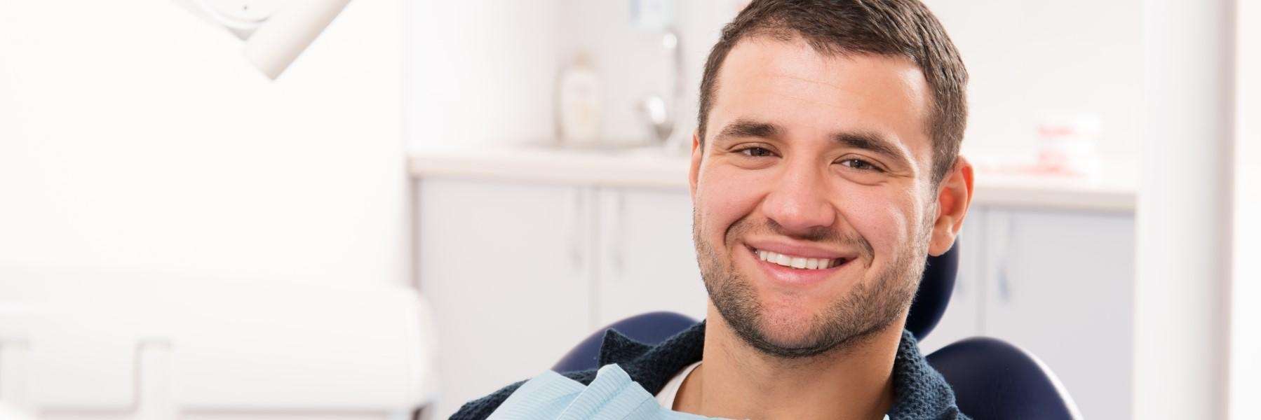 Man smiling confidently after a successful root canal treatment in Topeka, KS.